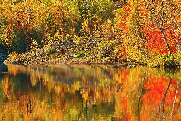 Autumn colors and Precambrian Shield rock reflected in Simon Lake Simon Lake Park Conservation Area Greater Sudbury, Ontario, Canada