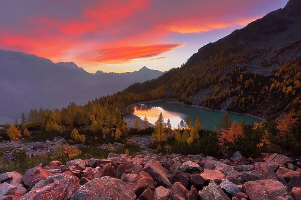 Autumnal sunrise at Lake Lagazzuolo. Valmalenco, Valtellina, Lombardy, Italy