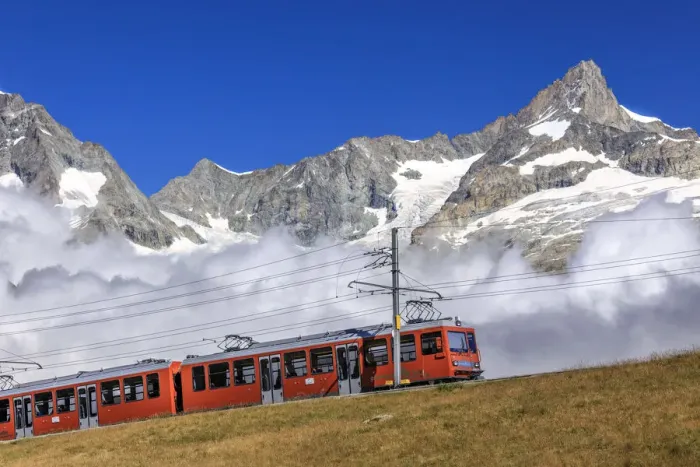 Framed Print : The Bahn train on its route with high peaks and mountain range in the background