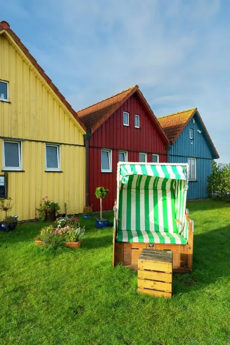 Framed Print : Beach chair in front of colorful houses of Seefohrerhus restaurant, Wittdun harbor, Amrum island, Nordfriesland, Schleswig-Holstein, Germany Framed Print : Beach chair in front of colorful houses of Seefohrerhus restaurant, Wittdun harbor, Amrum island, Nordfriesland, Schleswig-Holstein, Germany
