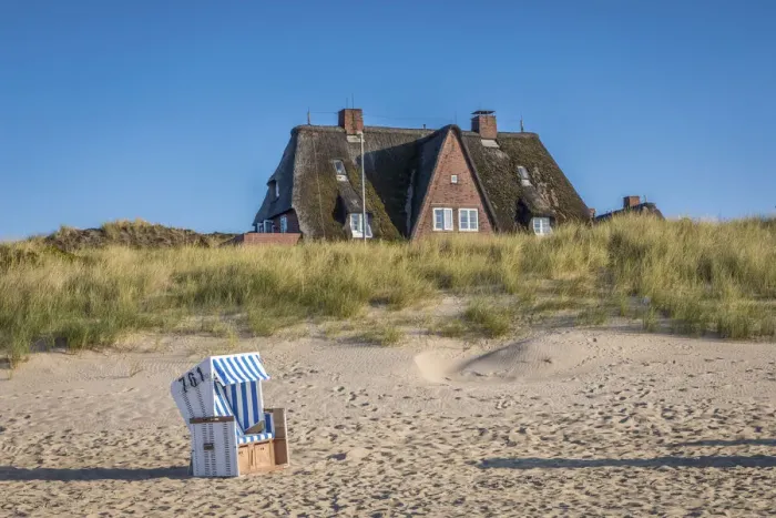 Framed Print : Beach chair and thatched roof house on the east beach of List, Sylt, Schleswig-Holstein Framed Print : Beach chair and thatched roof house on the east beach of List, Sylt, Schleswig-Holstein