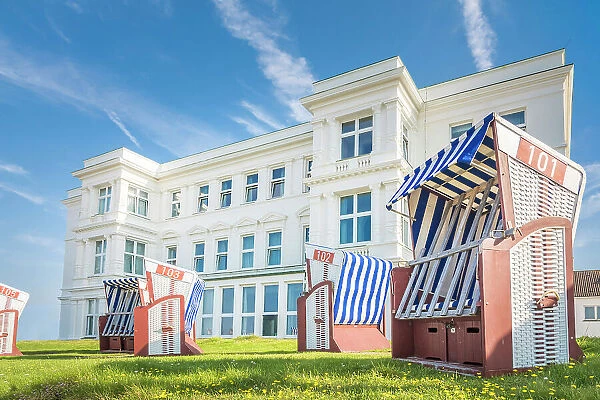 Beach chairs in front of a historic hotel house on the western beach of Norderney, East Frisian Islands, East Frisia, Lower Saxony, Germany
