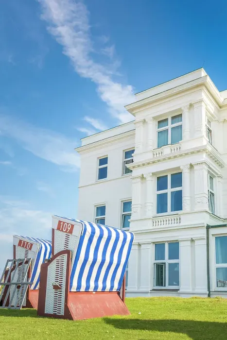 Framed Print : Beach chairs in front of a historic hotel house on the western beach of Norderney, East Frisian Islands, East Frisia, Lower Saxony, Germany Framed Print : Beach chairs in front of a historic hotel house on the western beach of Norderney, East Frisian Islands, East Frisia, Lower Saxony, Germany