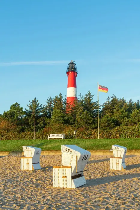 Framed Print : Beach chairs near German flag and Hornum lighthouse in background at sunrise, Hornum beach, Sylt, Nordfriesland, Schleswig-Holstein, Germany Framed Print : Beach chairs near German flag and Hornum lighthouse in background at sunrise, Hornum beach, Sylt, Nordfriesland, Schleswig-Holstein, Germany