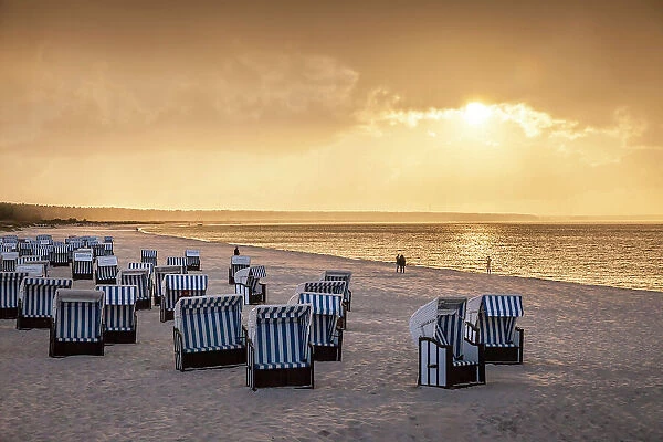 Beach chairs with storm clouds at sunset in Prerow, Mecklenburg-Western Pomerania, Baltic Sea, North Germany, Germany