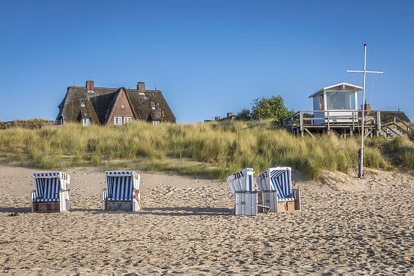 Beach chairs and thatched roof house on the east beach of List, Sylt, Schleswig-Holstein