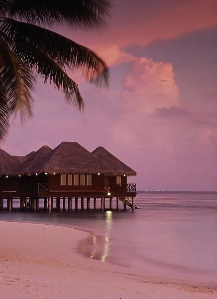 Beach and water villas at sunset, Maldive Islands