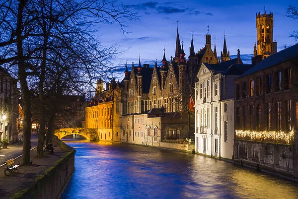 Belgium, Bruges, canalside buildings and Belfort Tower, dusk
