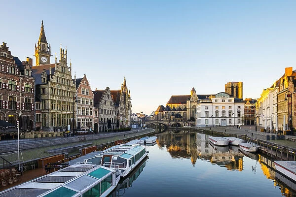Belgium, Flanders, Ghent (Gent). The Leie River and buildings along Graslei quay at dawn