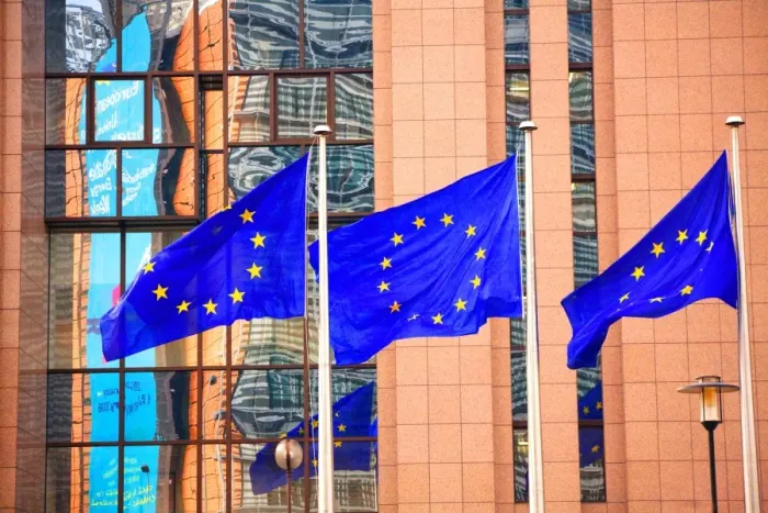 Framed Print : Belgium, Wallonia, Brussels; Three flags carrying the European Union emblem in front of the E Framed Print : Belgium, Wallonia, Brussels; Three flags carrying the European Union emblem in front of the E