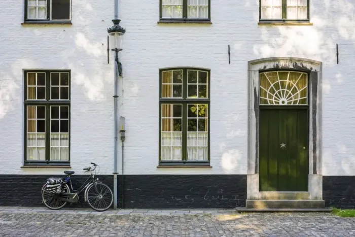 Framed Print : Belgium, West Flanders (Vlaanderen), Bruges (Brugge). Bicycle next to a house in the Begijnhof