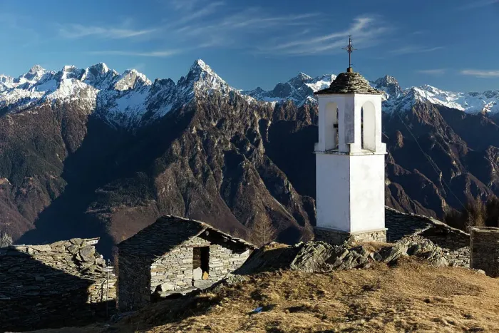 Framed Print : The bell tower of Alpe Scima, with Pizzo di Prata in the background, in winter Framed Print : The bell tower of Alpe Scima, with Pizzo di Prata in the background, in winter