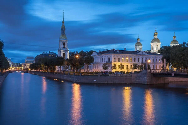 The bell tower and domes of Saint Nicholas Naval Cathedral on Griboyedov Canal at dusk