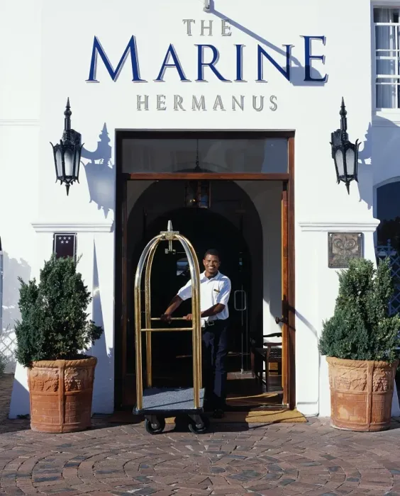 Framed Print : A bellboy pushes the luggage trolley through the Hotel entrance Framed Print : A bellboy pushes the luggage trolley through the Hotel entrance