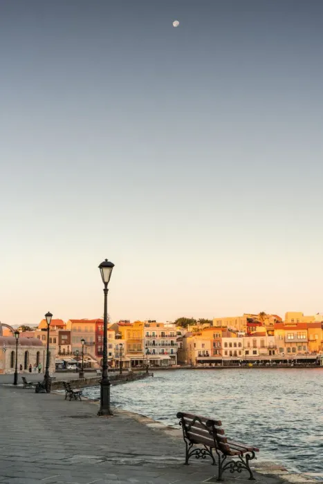 Framed Print : Bench on waterfront in the old Venetian harbour of Chania at dawn, Crete island, Greece