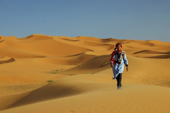 Framed Print : Berber man walking in the Erg Chebbi sand dunes, Sahara Desert, Merzouga, Morocco Framed Print : Berber man walking in the Erg Chebbi sand dunes, Sahara Desert, Merzouga, Morocco