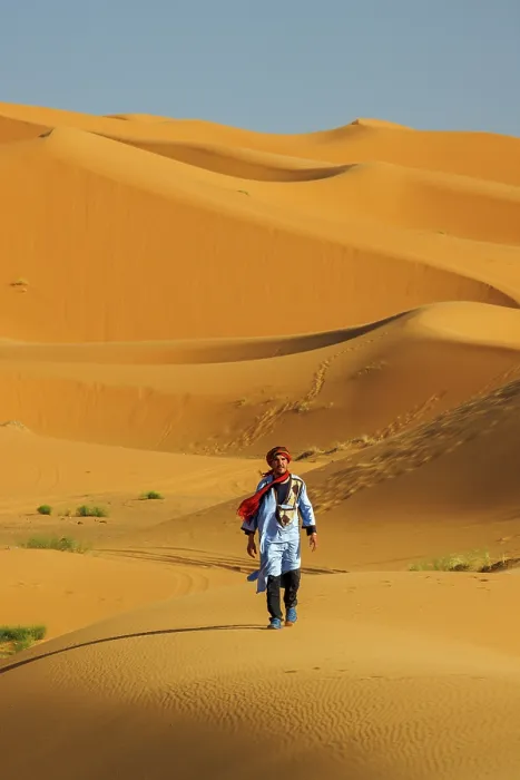 Framed Print : Berber man walking in the Erg Chebbi sand dunes, Sahara Desert, Merzouga, Morocco Framed Print : Berber man walking in the Erg Chebbi sand dunes, Sahara Desert, Merzouga, Morocco