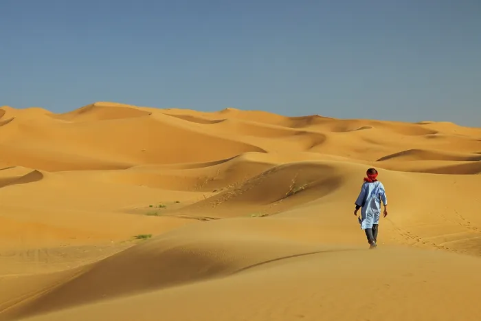 Framed Print : Berber man walking in the Erg Chebbi sand dunes, Sahara Desert, Merzouga, Morocco Framed Print : Berber man walking in the Erg Chebbi sand dunes, Sahara Desert, Merzouga, Morocco
