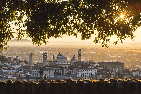 Bergamo, Lombardy, Italy. High angle view over Upper Town (Citta Alta) at sunrise