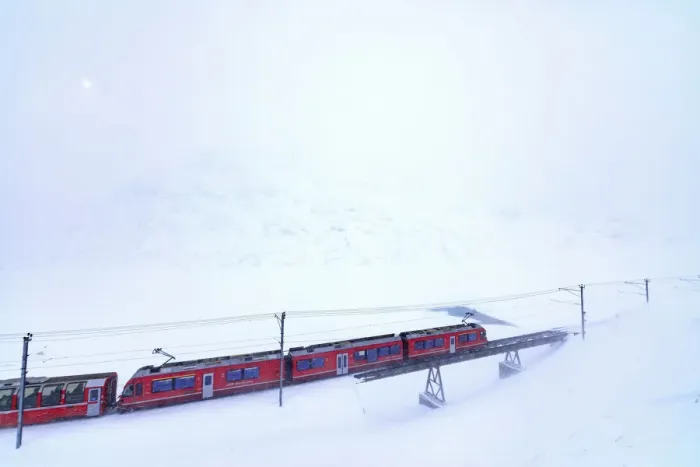 Framed Print : Bernina Express train at Bernina Pass during a snowstorm, canton of GraubAonden, Engadin