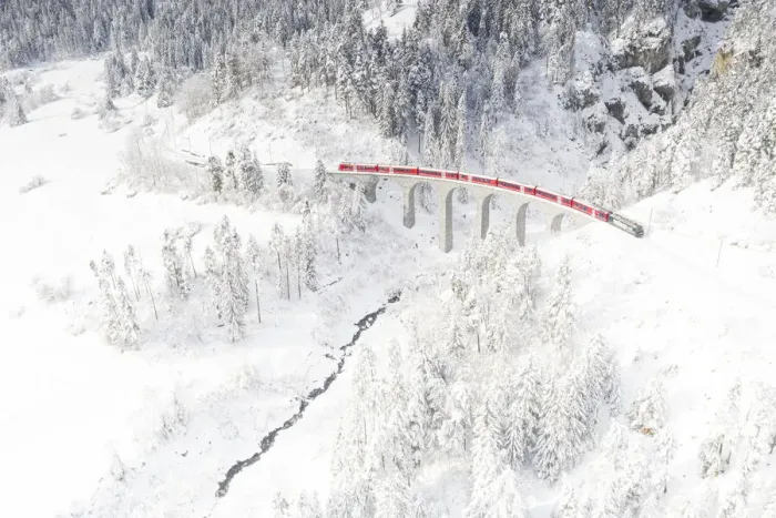 Framed Print : Bernina Express train on Landwasser viaduct framed by snow capped woods, Filisur Framed Print : Bernina Express train on Landwasser viaduct framed by snow capped woods, Filisur