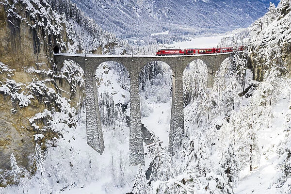 Bernina Express train on Landwasser viaduct in winter, Filisur, canton of Graubunden
