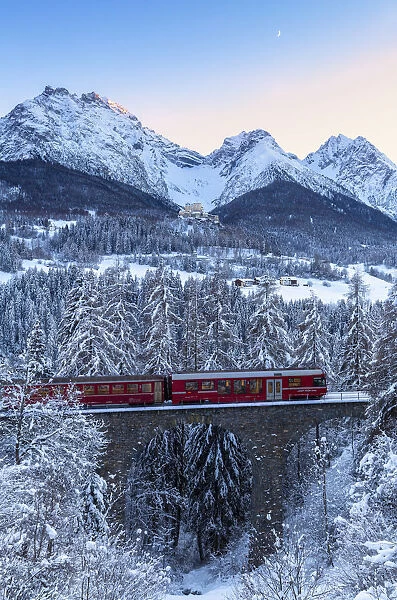 Bernina Express transit on the viaduct in winter. Lower Engadine, Canton of Grisons