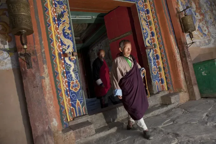 Framed Print : Bhutan. A monk walking through a doorway at the Gangtey Gompa