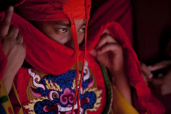 Bhutan. Participants at the tsechu in Wangdue Phodrang getting ready for a performance