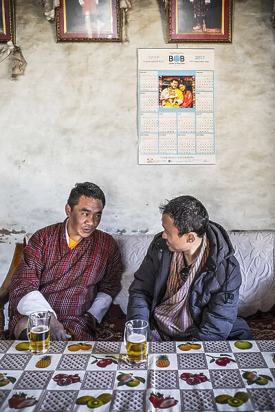 Two Bhutanese men drinking beer in a local bar, Ura, Bumthang District, Bhutan