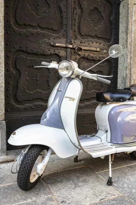 Framed Print : Bicolored Lambretta Innocenti scooter in front of ancient doorway, Morbegno, Sondrio