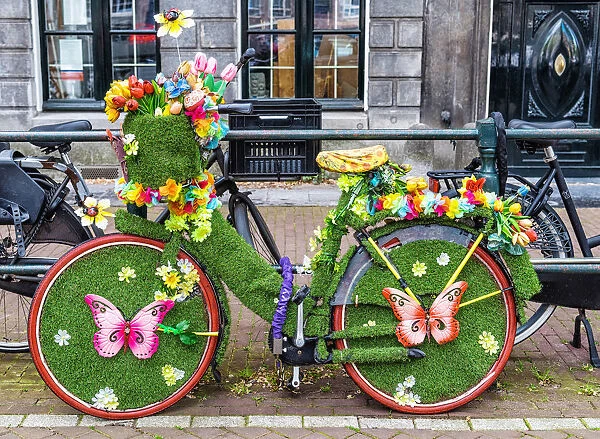 A bicycle decorated with butterflies and flowers in Amsterdam, the Netherlands