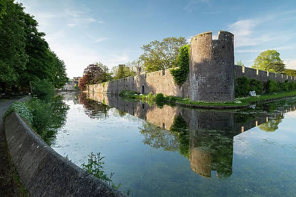 The Bishop's Palace reflected in its moat, Wells, Somerset, England. Spring (May) 2019
