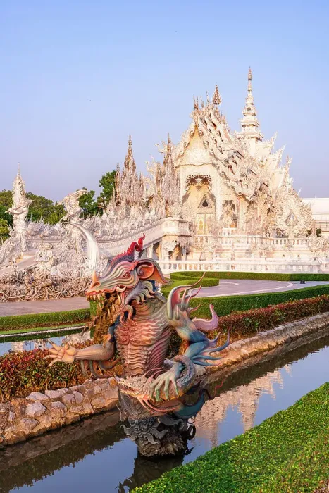 Framed Print : Bizarre statue of a dragon in the canals of lush gardens surrounding the Wat Rong Khun (White Temple), Chiang Rai, Thailand Framed Print : Bizarre statue of a dragon in the canals of lush gardens surrounding the Wat Rong Khun (White Temple), Chiang Rai, Thailand