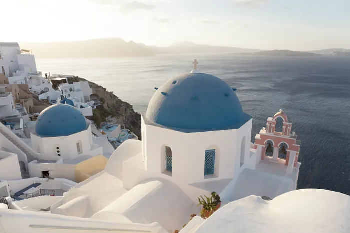 Framed Print : Blue domed churches and white-washed houses with caldera view in the distance, Oia, Santorini, Cyclades Islands, Greece Framed Print : Blue domed churches and white-washed houses with caldera view in the distance, Oia, Santorini, Cyclades Islands, Greece