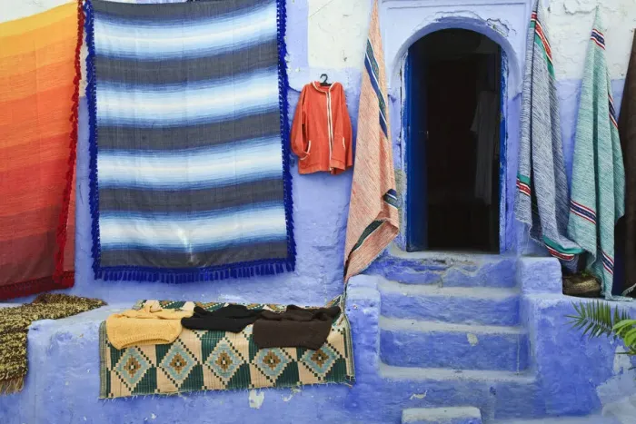 Framed Print : Blue doorway and traditional Moroccan fabrics, Chefchaouen, Morocco Framed Print : Blue doorway and traditional Moroccan fabrics, Chefchaouen, Morocco