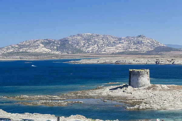 Blue sea and medieval tower surround La Pelosa Beach Stintino Asinara National Park