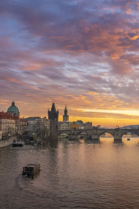 Framed Print : Boat going towards Charles Bridge and Church of Saint Francis of Assisi with Old Town