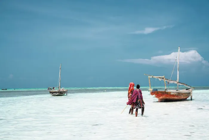 Framed Print : Boat and masai people on the shore at low tide, Nungwi, Zanzibar, Tanzania, Africa Framed Print : Boat and masai people on the shore at low tide, Nungwi, Zanzibar, Tanzania, Africa