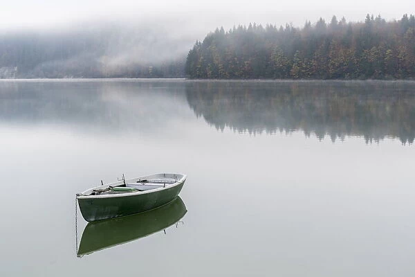 Boat on Sylvenstein Lake in the morning. Bad Tolz-Wolfratshausen district, Bavaria, Germany