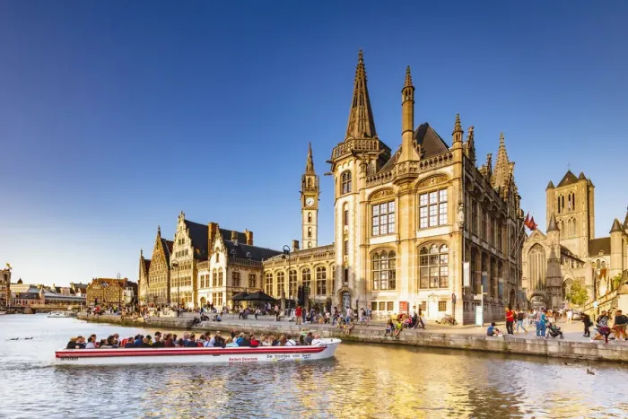 Framed Print : A boat with tourists on the canal with the Ghent town buildings reflecting at sunset Framed Print : A boat with tourists on the canal with the Ghent town buildings reflecting at sunset