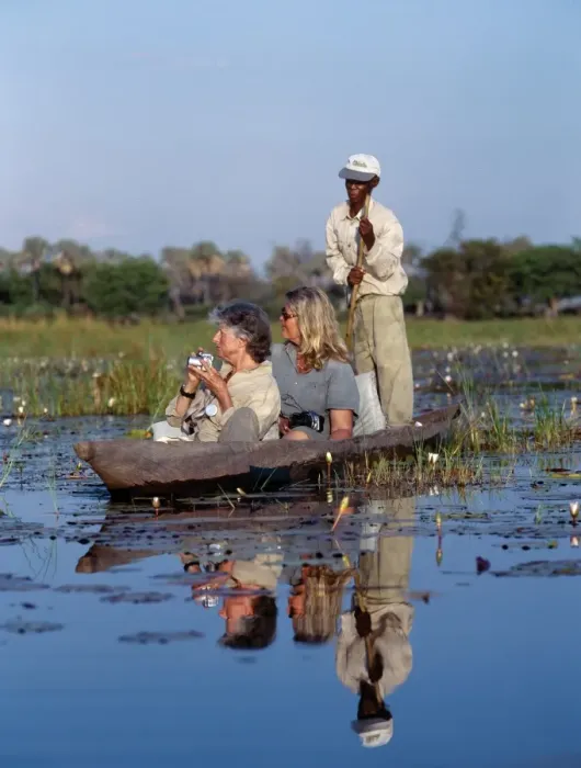 Framed Print : A boatman in his mokoro dug-out canoe takes tourists