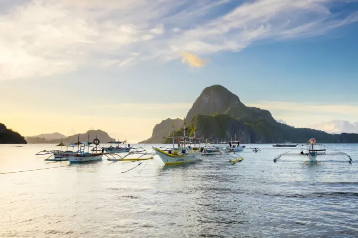 Framed Print : Boats anchored in Bacuit Bay and Cadlao Island at sunset seen from Caalan Beach, El Nido