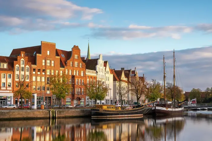 Framed Print : Boats anchored on Trave river and houses with traditional gables in background at sunset, Lubeck, UNESCO, Schleswig-Holstein, Germany Framed Print : Boats anchored on Trave river and houses with traditional gables in background at sunset, Lubeck, UNESCO, Schleswig-Holstein, Germany