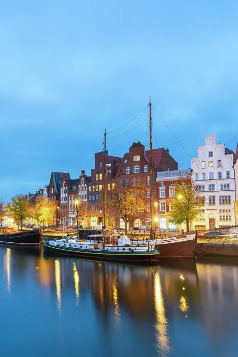 Framed Print : Boats anchored on Trave river and houses with traditional gables in background at twilight, Lubeck, UNESCO, Schleswig-Holstein, Germany Framed Print : Boats anchored on Trave river and houses with traditional gables in background at twilight, Lubeck, UNESCO, Schleswig-Holstein, Germany