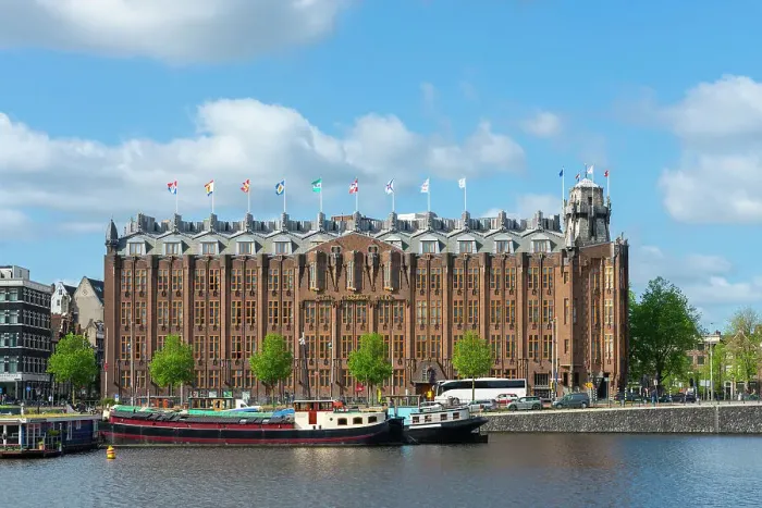 Framed Print : Boats moored in front of Grand Hotel Amrath, Amsterdam, Netherlands Framed Print : Boats moored in front of Grand Hotel Amrath, Amsterdam, Netherlands
