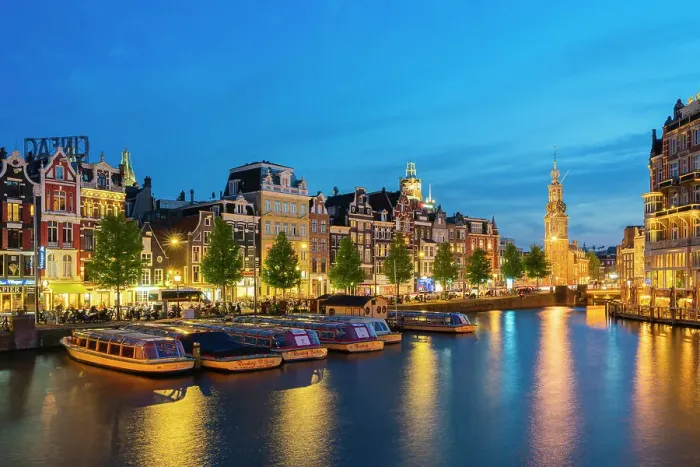 Framed Print : Boats moored along illuminated street on Amstel River and Munttoren tower at twilight, Amsterdam, Netherlands Framed Print : Boats moored along illuminated street on Amstel River and Munttoren tower at twilight, Amsterdam, Netherlands