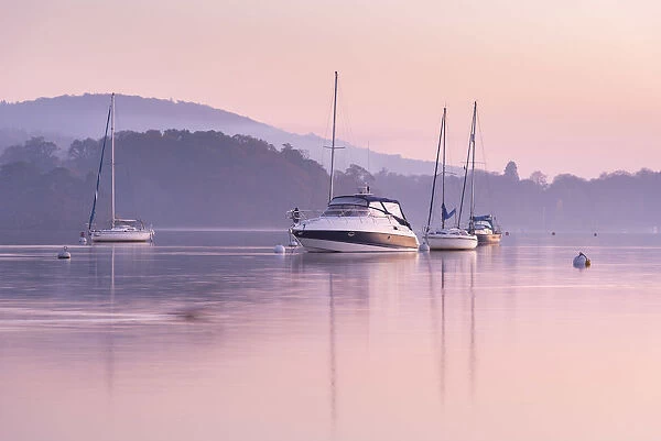 Boats moored on Lake Windermere at sunset, Bowness, Lake District, Cumbria, England