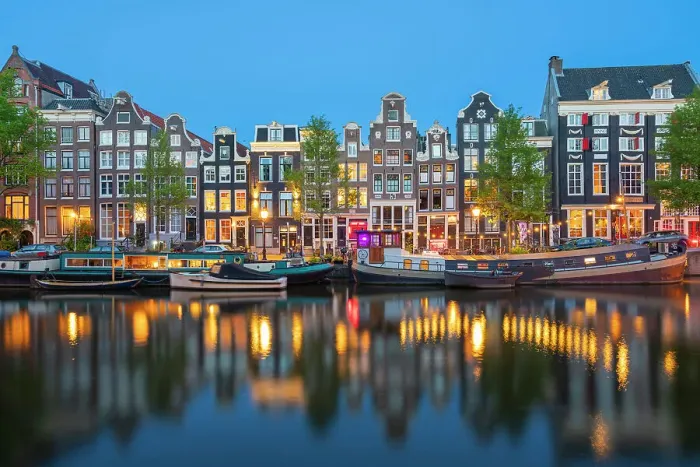 Framed Print : Boats moored in Singel canal near typical houses at twilight, Amsterdam, Netherlands Framed Print : Boats moored in Singel canal near typical houses at twilight, Amsterdam, Netherlands