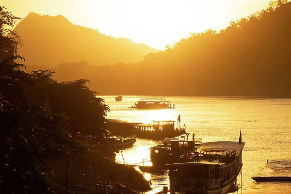 Boats at sunset on the Mekong river, Luang Prabang (ancient capital of Laos), Laos
